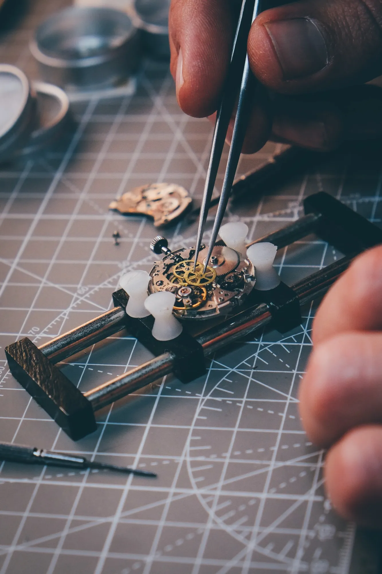 Tweezers at work on the Swiss movement of the first Bettél automatic, held in a movement holder